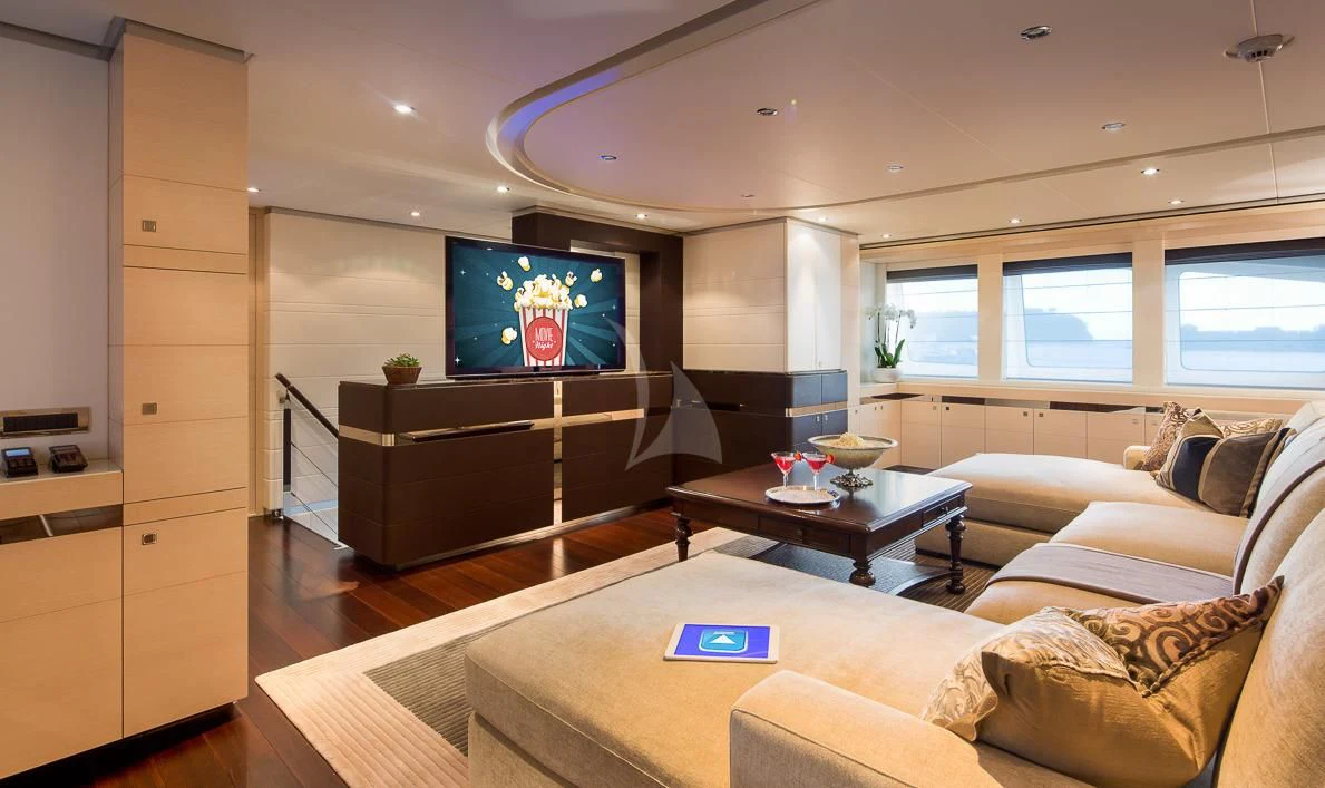 a living room with a tv and furniture aboard LADY L Yacht for Charter