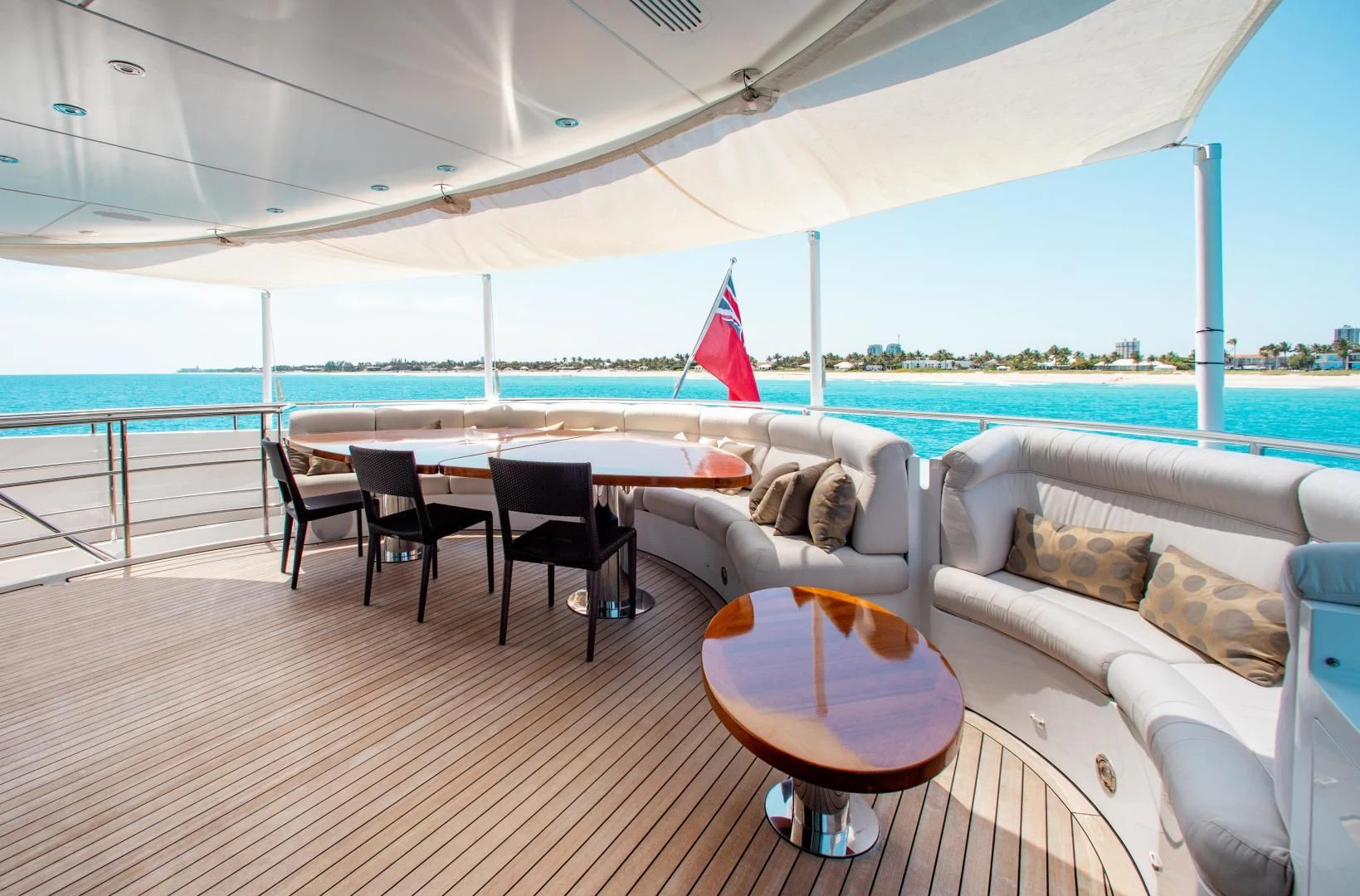 a table and chairs on a deck aboard LADY L Yacht for Charter