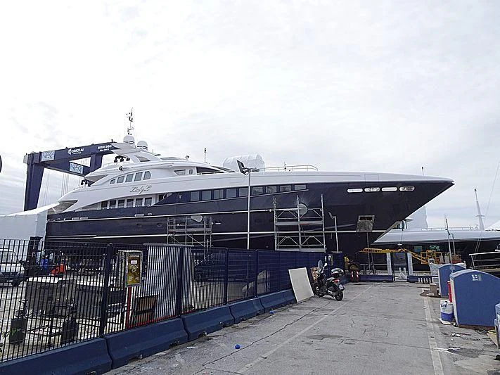 a large cruise ship docked aboard LADY L Yacht for Charter