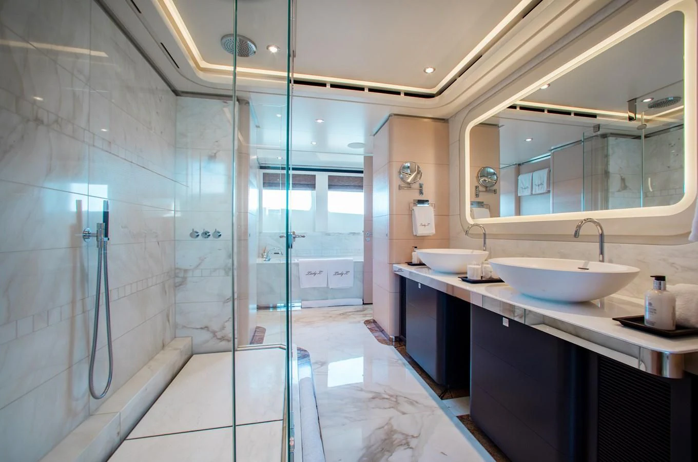 a bathroom with a glass shower aboard LADY L Yacht for Charter