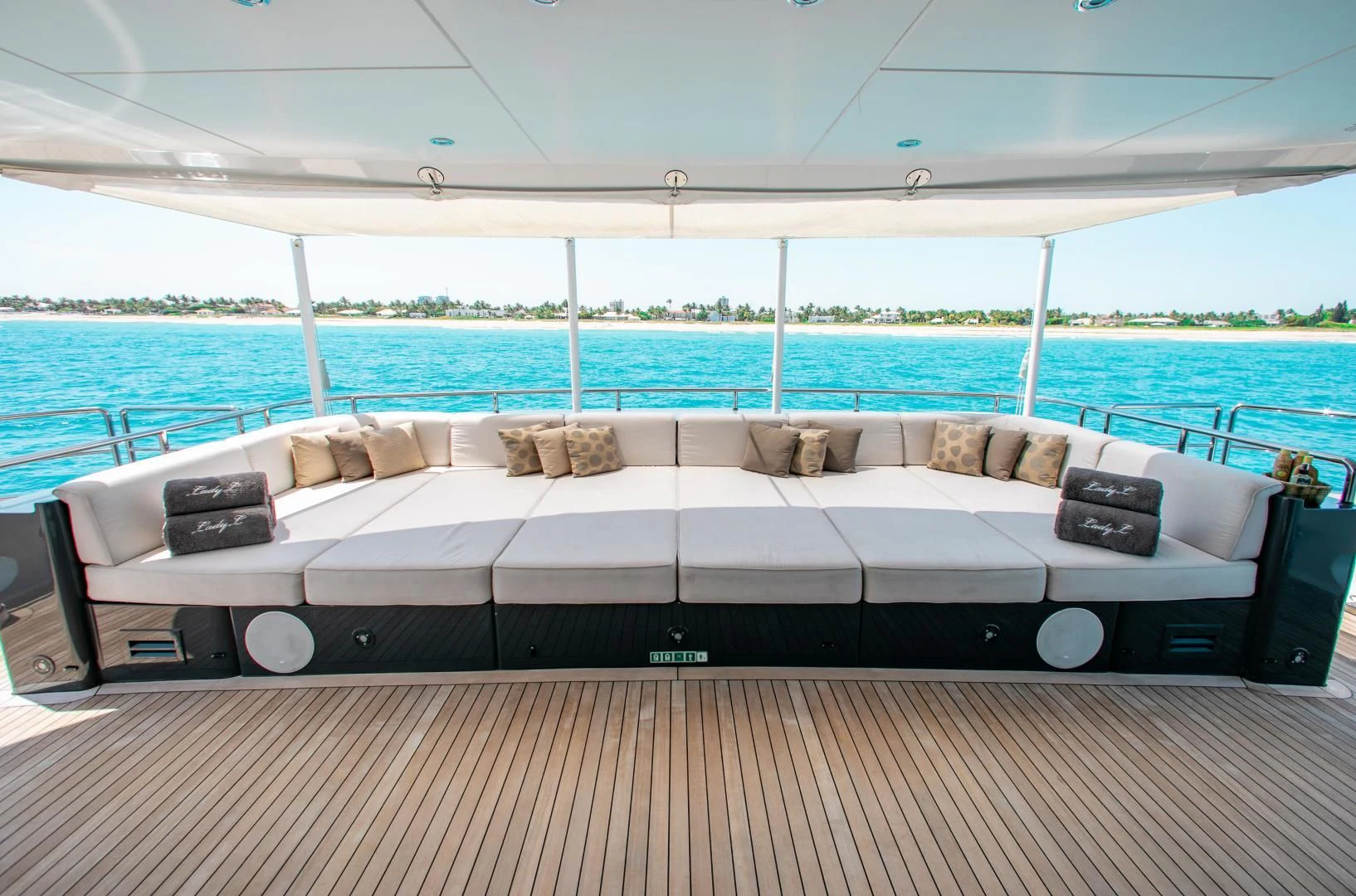 a large bed on a deck aboard LADY L Yacht for Charter