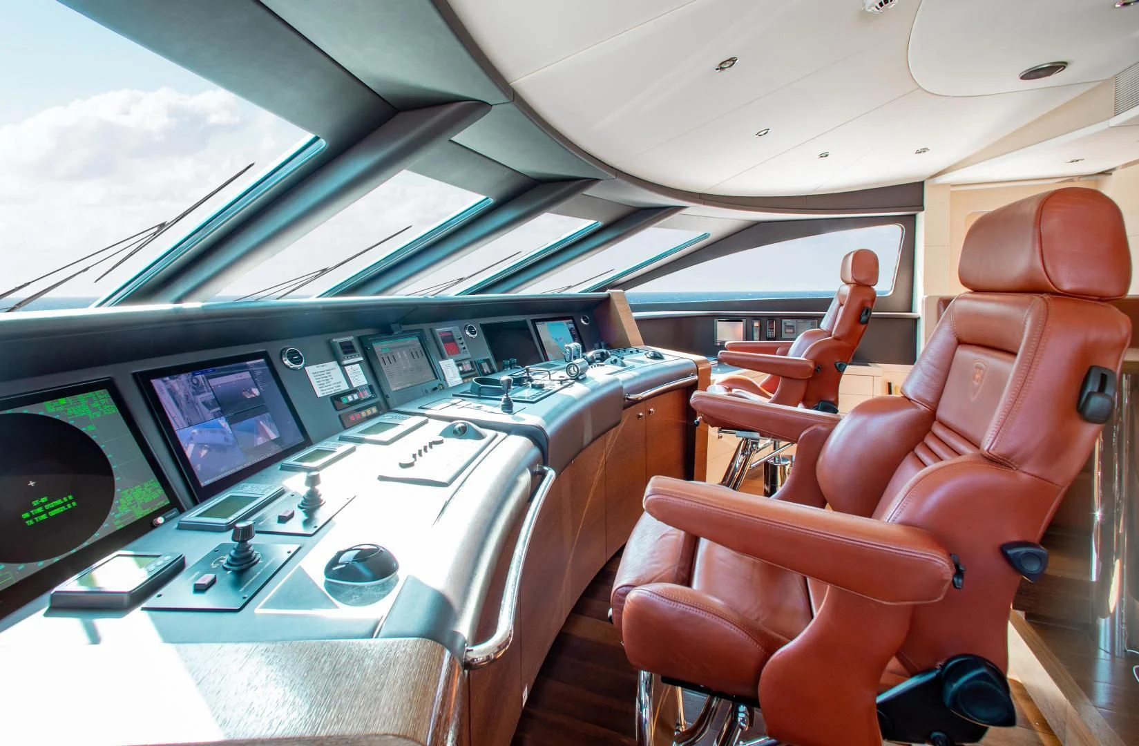 a room with a row of seats and a computer monitor aboard LADY L Yacht for Charter