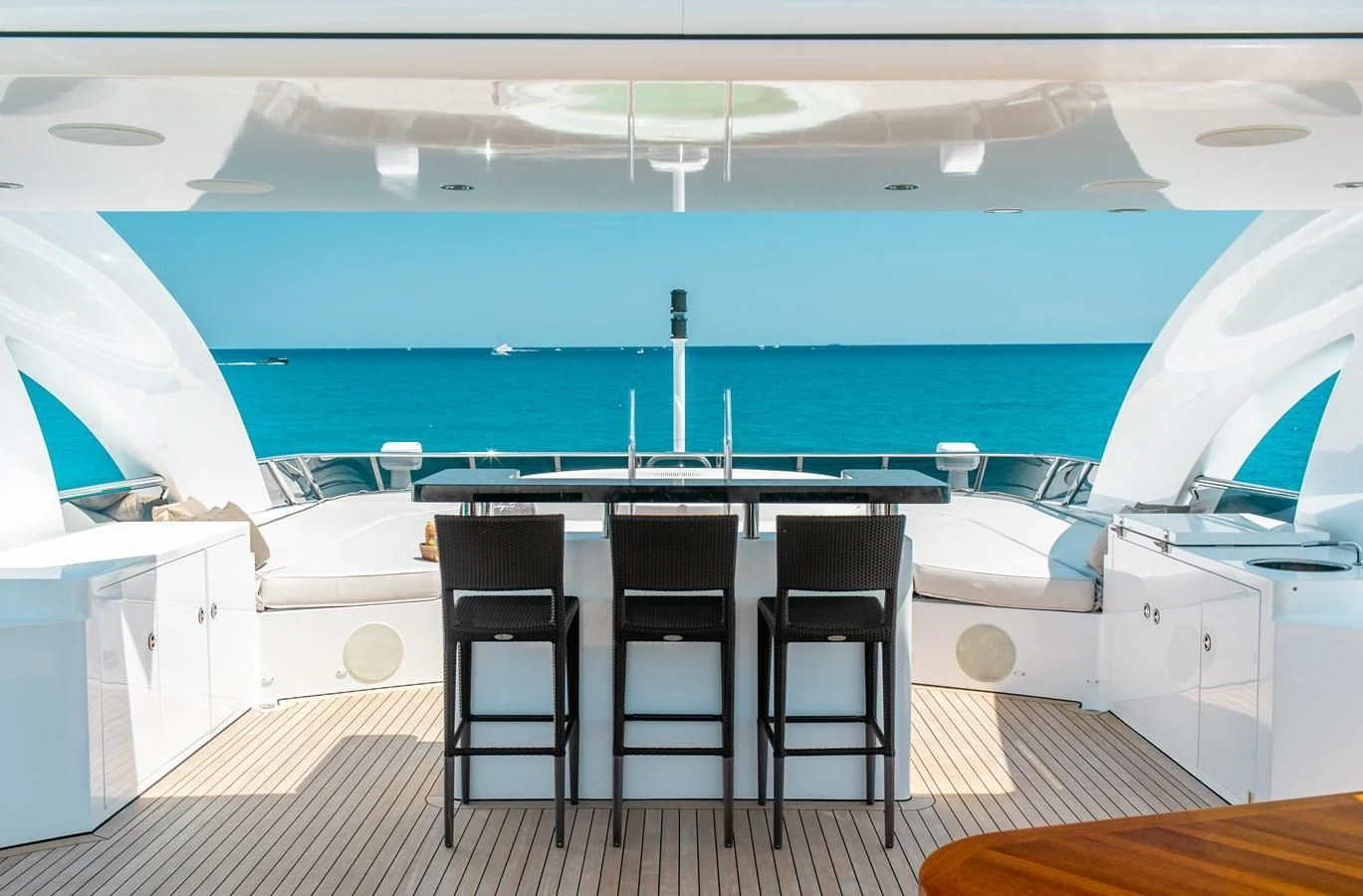 a room with a table chairs and a pool aboard LADY L Yacht for Charter