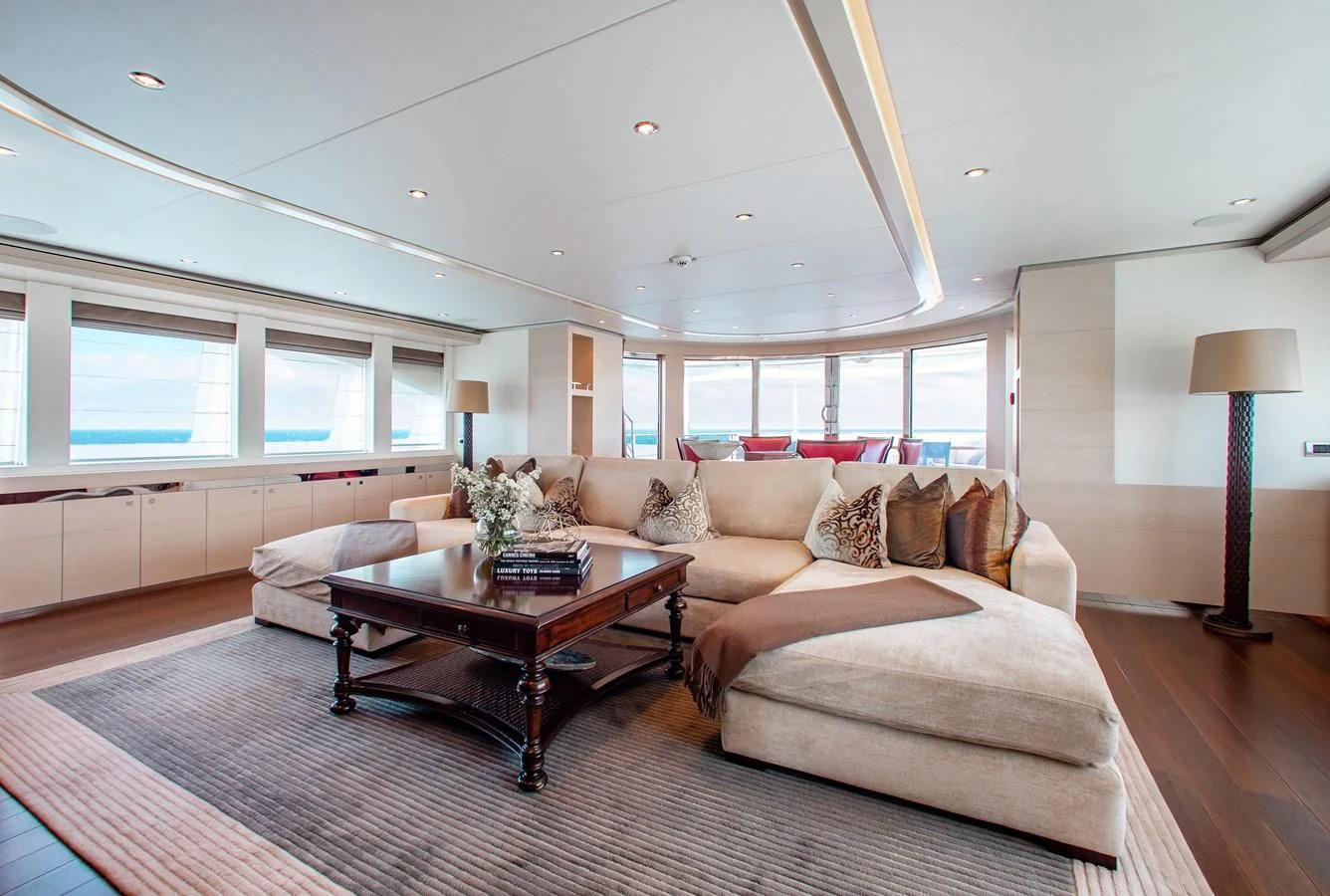 a living room with a couch and a coffee table aboard LADY L Yacht for Charter
