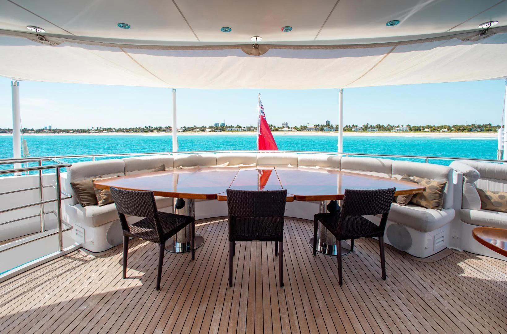 a table and chairs on a deck aboard LADY L Yacht for Charter