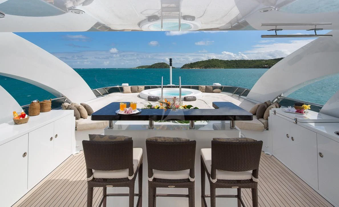 a large white boat with chairs around it aboard LADY L Yacht for Charter