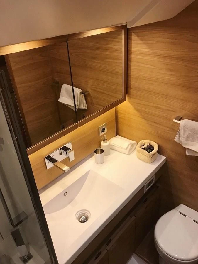 a bathroom with a sink and a mirror aboard ONE SHOT Yacht for Sale