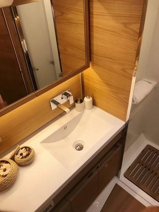 a bathroom with a large mirror aboard ONE SHOT Yacht for Sale