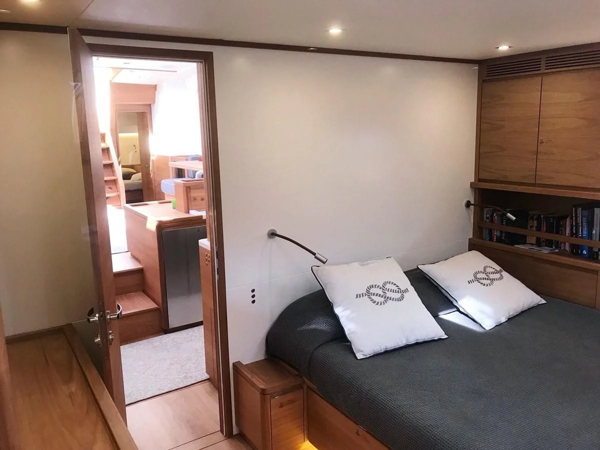 a bedroom with a bed and a mirror aboard ONE SHOT Yacht for Sale