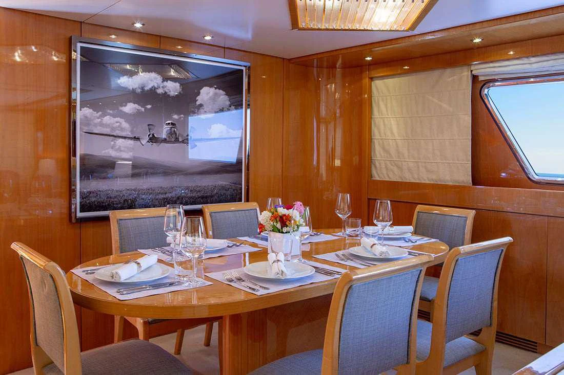 a restaurant with tables and chairs aboard THE BIRD Yacht for Charter