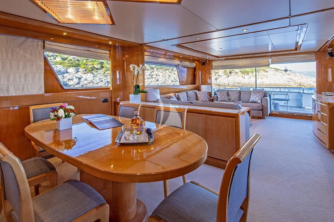 a large dining table in a cabin aboard THE BIRD Yacht for Charter