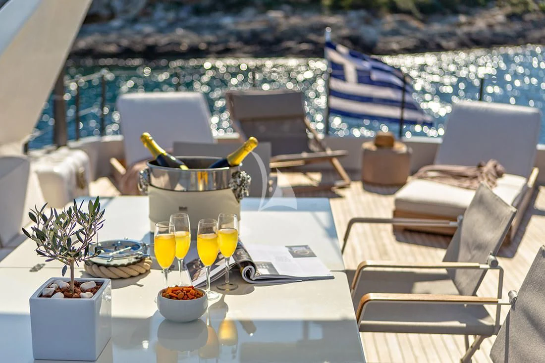 a table with chairs and food on it aboard THE BIRD Yacht for Charter