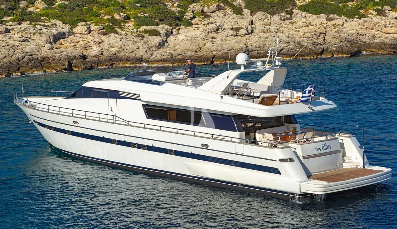 a white boat on the water aboard THE BIRD Yacht for Charter