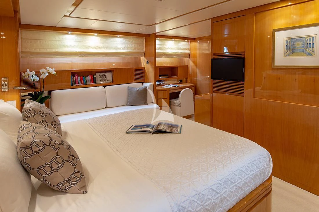 a room with a bed and a television aboard THE BIRD Yacht for Charter