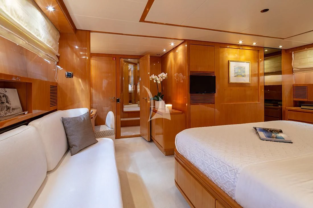 a room with a bed and a table aboard THE BIRD Yacht for Charter