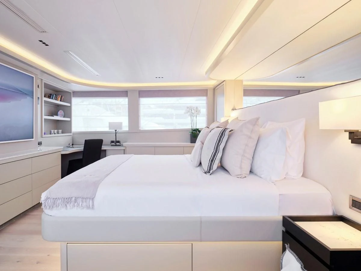 a bedroom with a bed and a desk aboard ENDLESS SUMMER Yacht for Sale