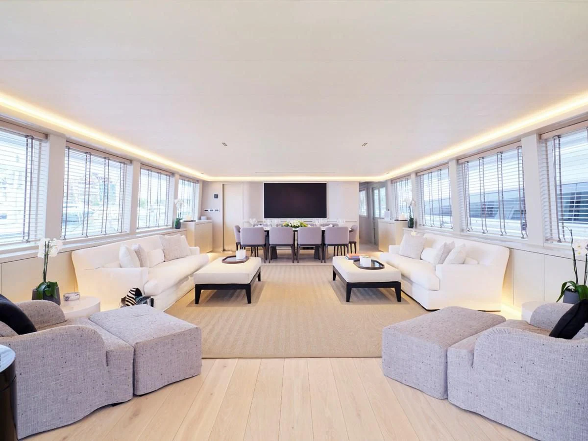 a living room with white couches aboard ENDLESS SUMMER Yacht for Sale