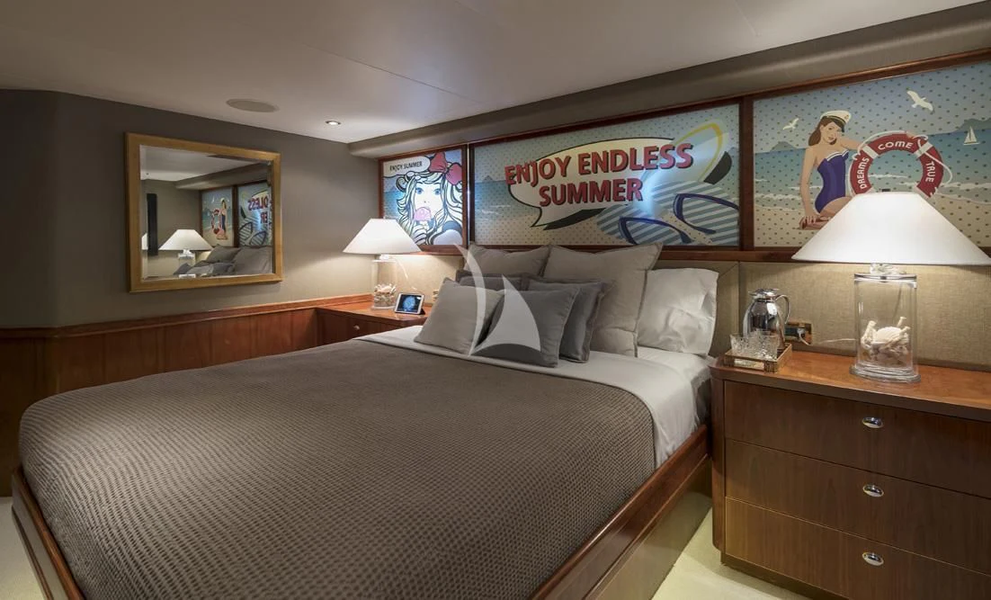 a bedroom with a large bed and a large painting on the wall aboard ENDLESS SUMMER Yacht for Sale