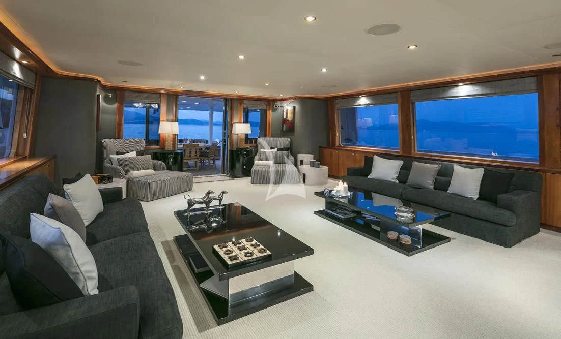 a living room with a large screen aboard ENDLESS SUMMER Yacht for Sale