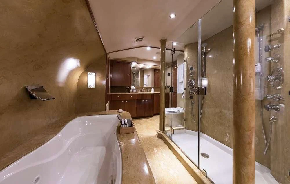 a bathroom with a bathtub and sinks aboard ENDLESS SUMMER Yacht for Sale