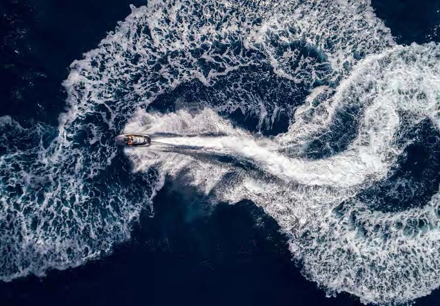 a plane flying over a mountain aboard ENDLESS SUMMER Yacht for Sale