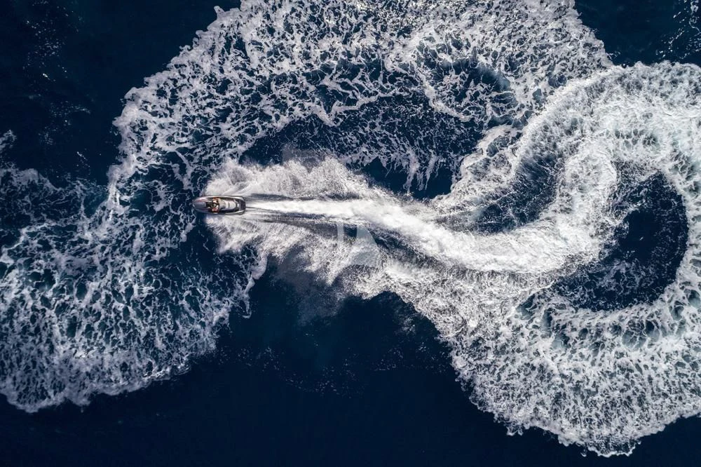 a plane flying over a mountain aboard ENDLESS SUMMER Yacht for Sale