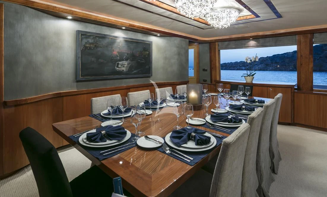 a dining room with a table set aboard ENDLESS SUMMER Yacht for Sale