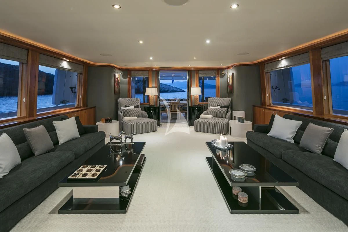 a living room with a large glass coffee table and a large window aboard ENDLESS SUMMER Yacht for Sale