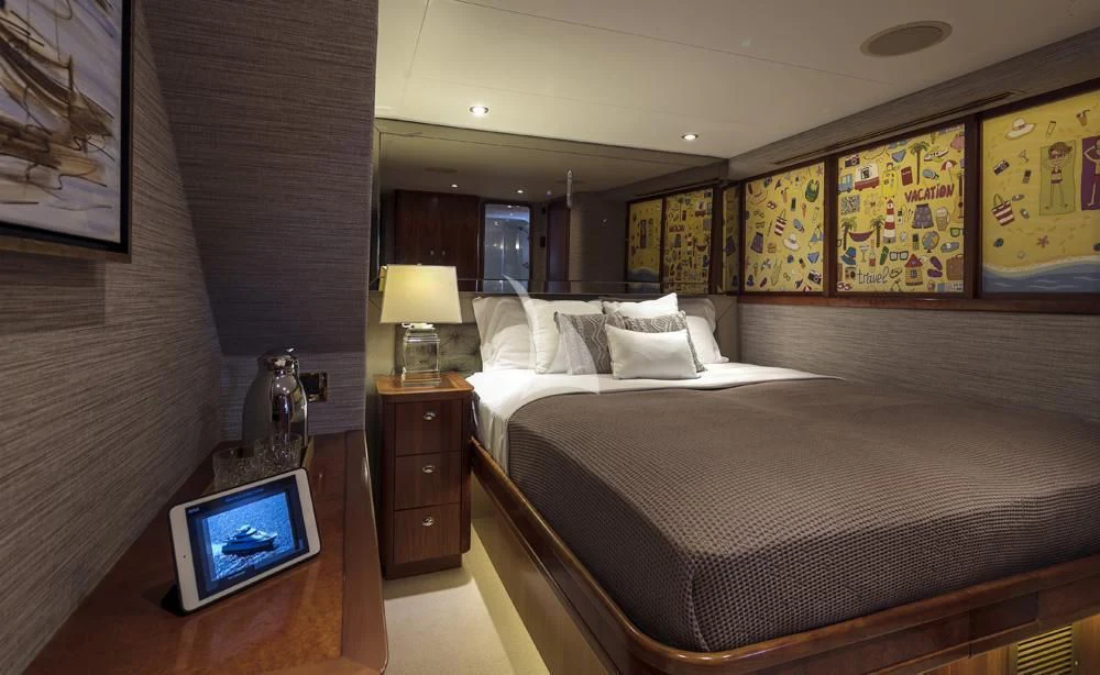 a bedroom with a bed and a television aboard ENDLESS SUMMER Yacht for Sale