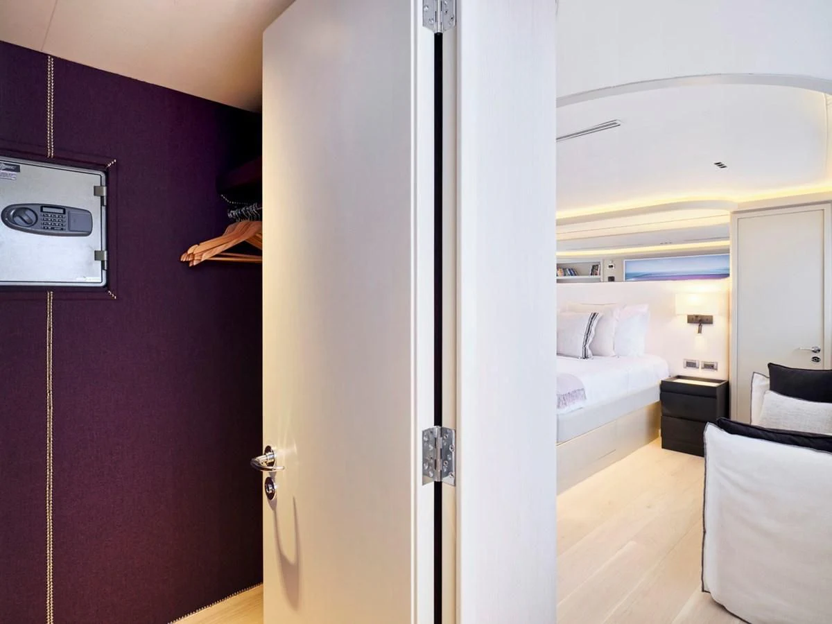 a room with a bed and a television aboard ENDLESS SUMMER Yacht for Sale