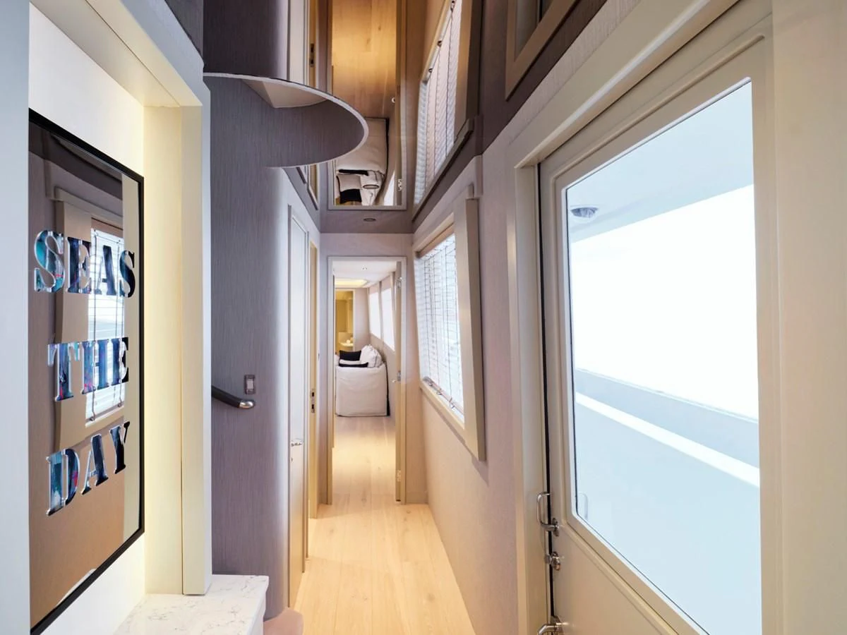 a hallway with a window and a door aboard ENDLESS SUMMER Yacht for Sale