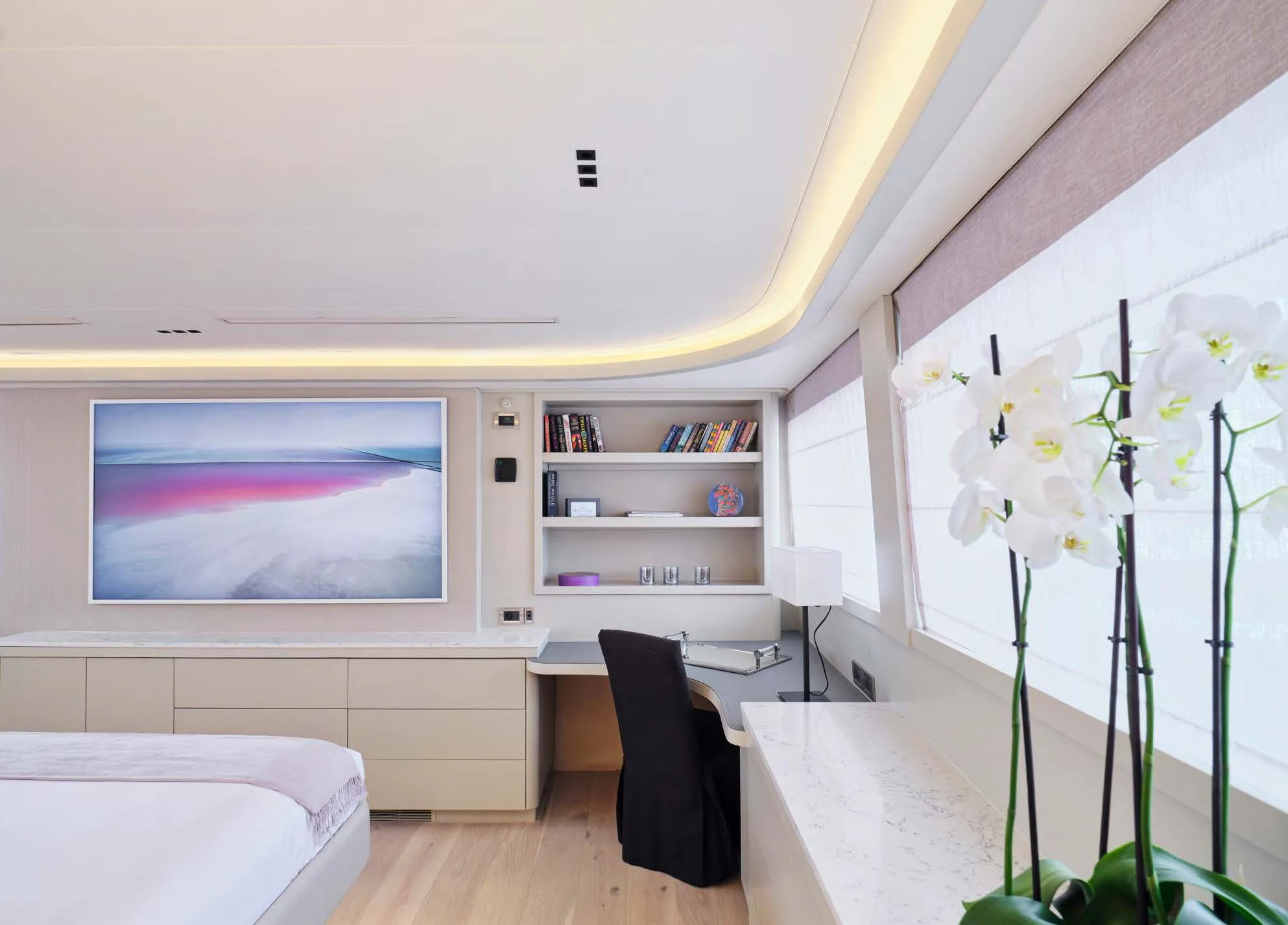 a room with a tv and a shelf with flowers aboard ENDLESS SUMMER Yacht for Sale
