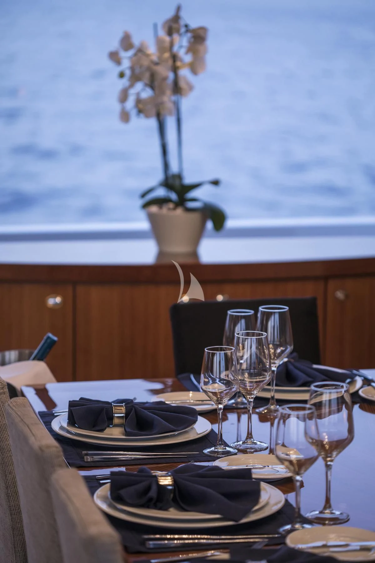 a table with wine glasses and plates aboard ENDLESS SUMMER Yacht for Sale