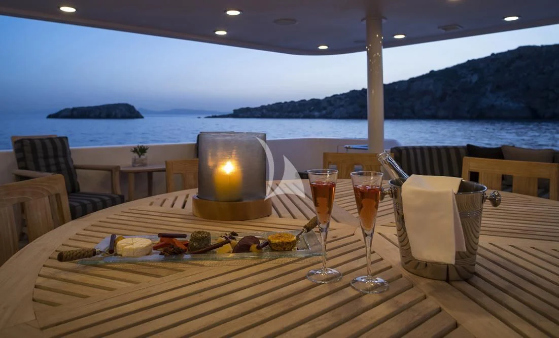 a table with food and glasses on it aboard ENDLESS SUMMER Yacht for Sale