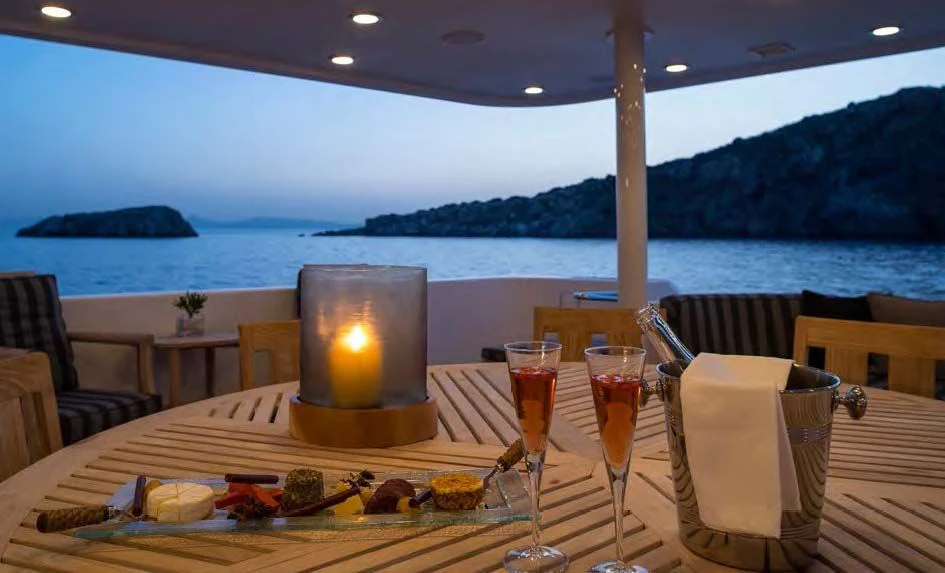 a table with food and glasses on it aboard ENDLESS SUMMER Yacht for Sale