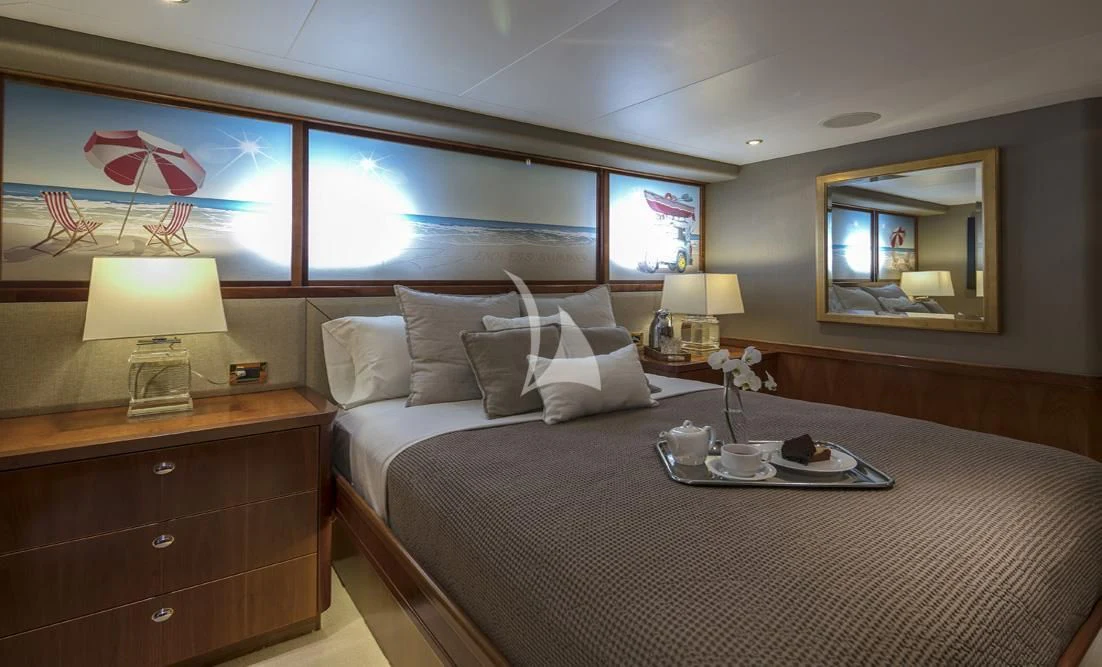 a bed with a white bed spread aboard ENDLESS SUMMER Yacht for Sale