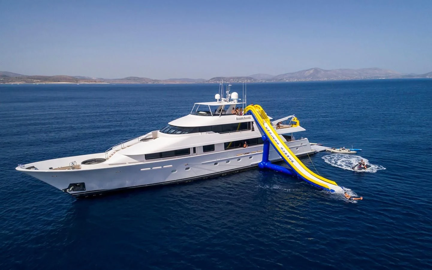 a boat with a yellow sail on the water aboard ENDLESS SUMMER Yacht for Sale