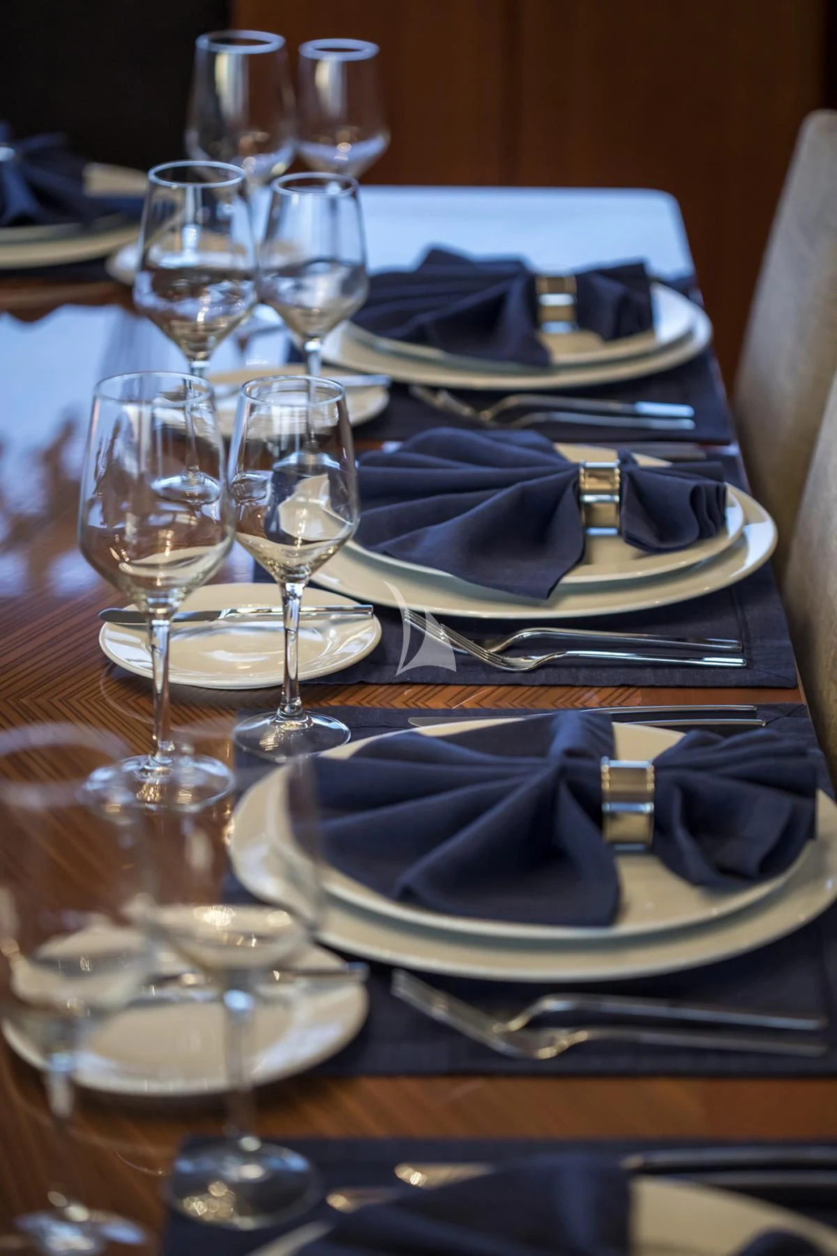a table with plates and glasses aboard ENDLESS SUMMER Yacht for Sale