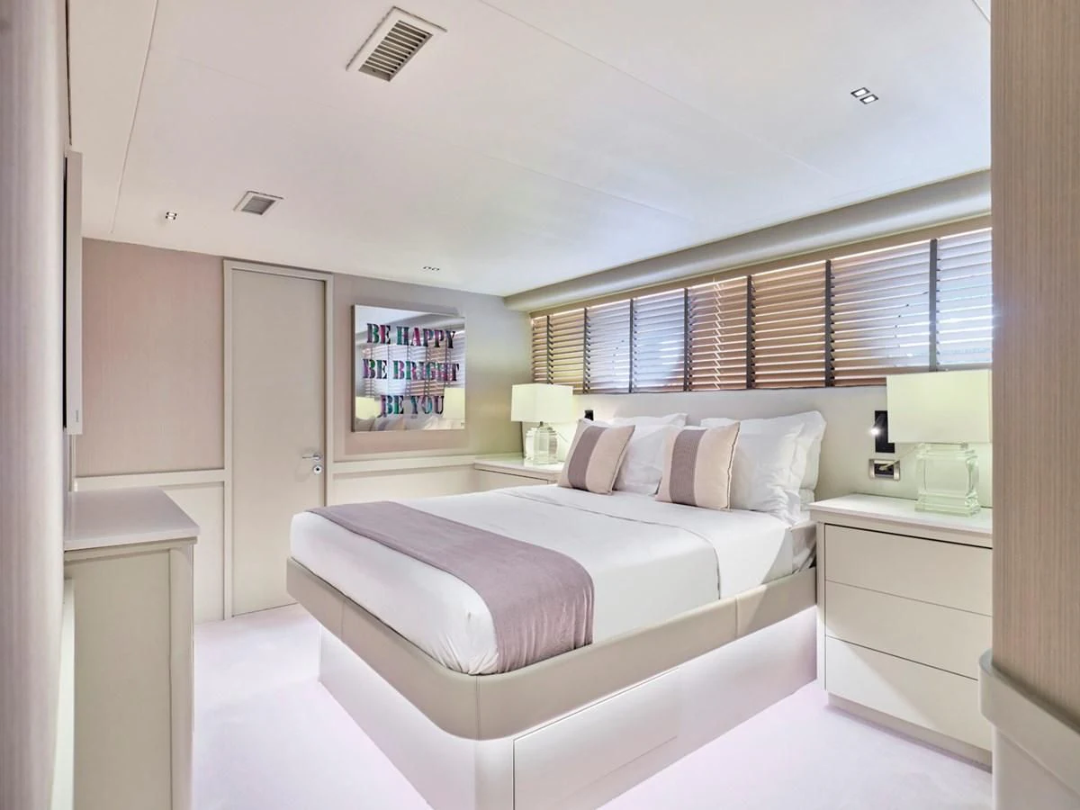 a bedroom with a bed and a window aboard ENDLESS SUMMER Yacht for Sale