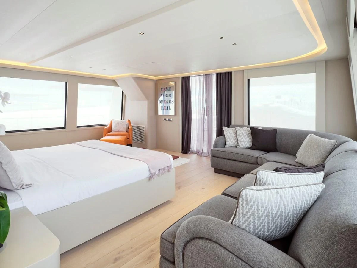 a bedroom with a bed and a couch aboard ENDLESS SUMMER Yacht for Sale