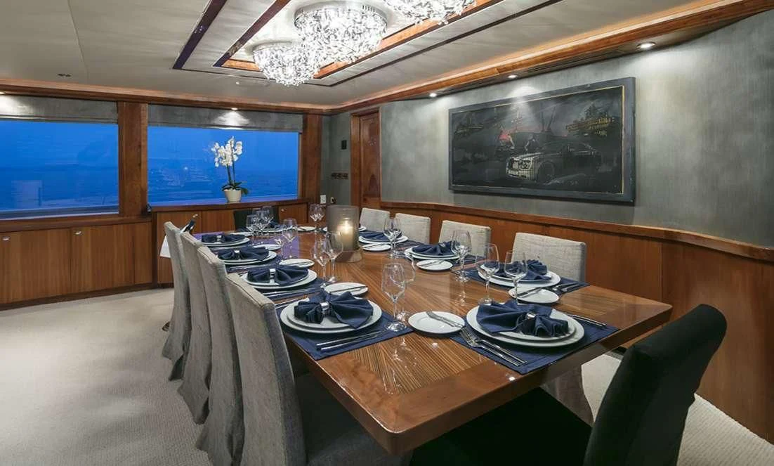 a dining table with plates and glasses aboard ENDLESS SUMMER Yacht for Sale