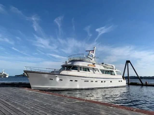 a white boat on a dock aboard LADY FAYE Yacht for Sale