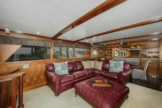a living room with a couch and a table aboard LADY FAYE Yacht for Sale