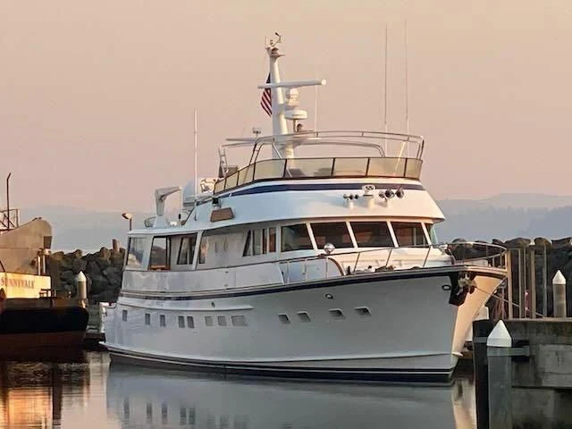 a white boat in a harbor aboard LADY FAYE Yacht for Sale