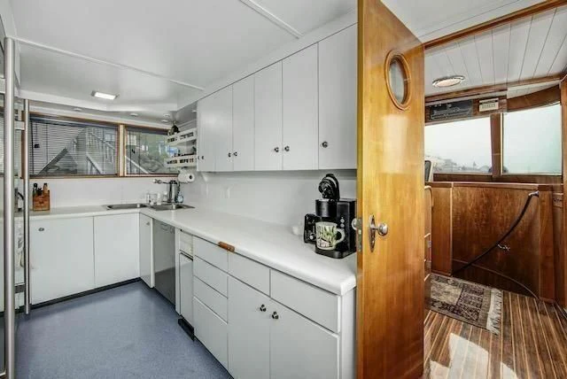a kitchen with white cabinets aboard LADY FAYE Yacht for Sale