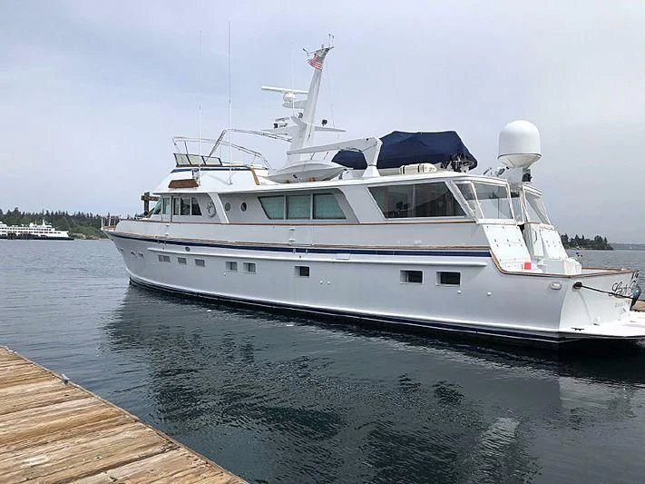 a white yacht docked at a dock aboard LADY FAYE Yacht for Sale
