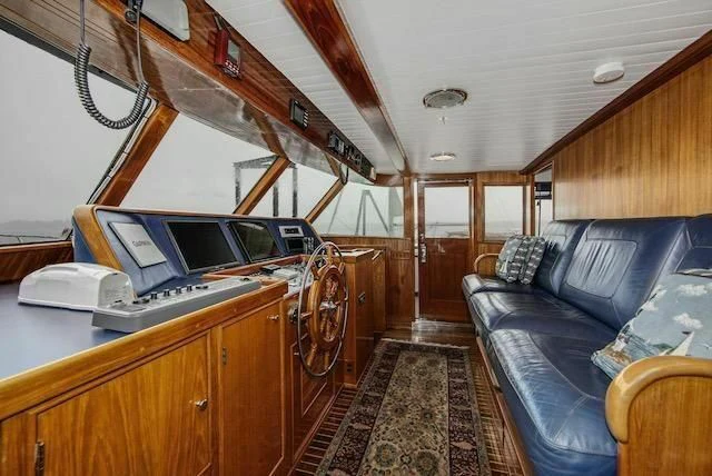 a boat with a couch and a computer aboard LADY FAYE Yacht for Sale