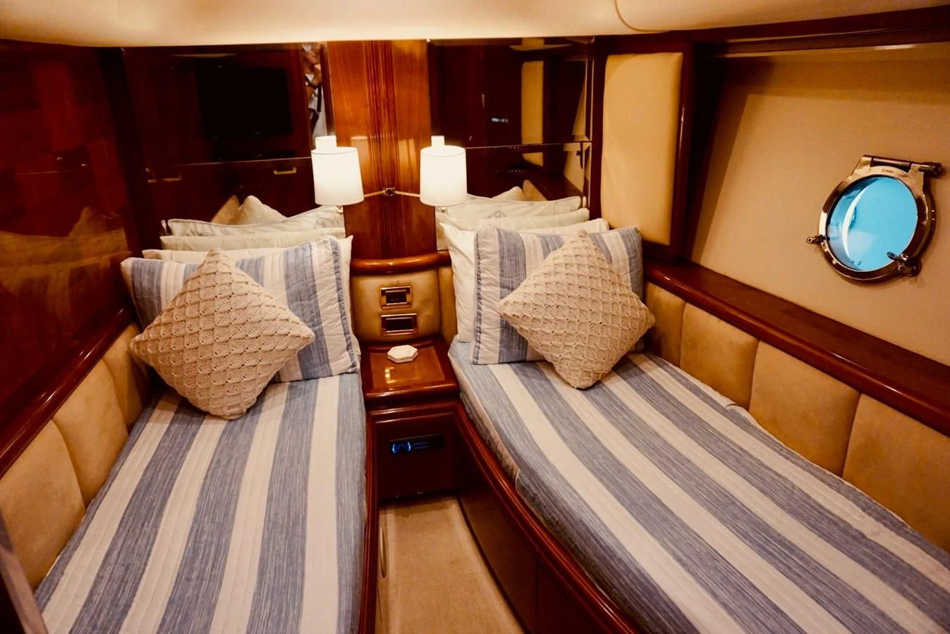 a room with a bed and a mirror aboard AZURE Yacht for Sale