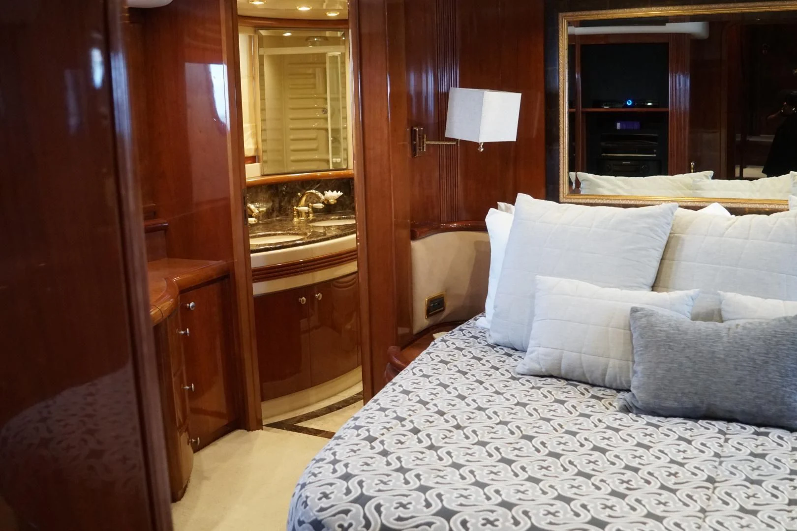 a bed with pillows and a mirror aboard AZURE Yacht for Sale