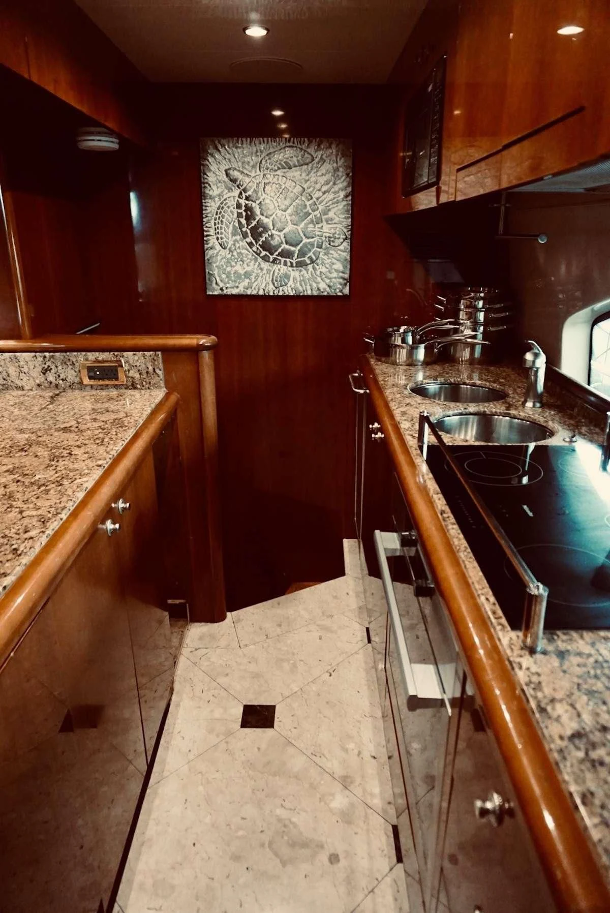 a kitchen with wooden cabinets aboard AZURE Yacht for Sale